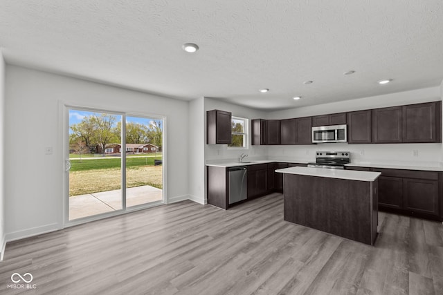 3913 Highcrest Rd, Indianapolis, IN 46239 - kitchen featuring appliances with stainless steel finishes, a sink, light countertops, dark brown cabinetry, and recessed lighting