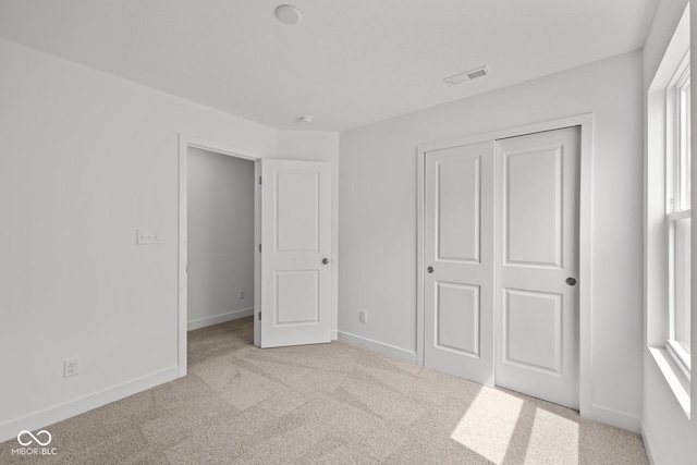 3913 Highcrest Rd, Indianapolis, IN 46239 - unfurnished bedroom featuring carpet, a closet, and baseboards