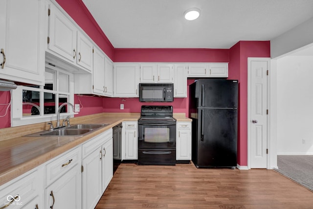 1847 Crystal Bay E Dr, Plainfield, IN 46168 - kitchen featuring white cabinetry, black appliances, light countertops, and a sink