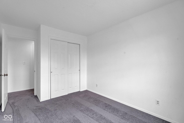 1847 Crystal Bay E Dr, Plainfield, IN 46168 - unfurnished bedroom featuring a closet, dark carpet, and baseboards