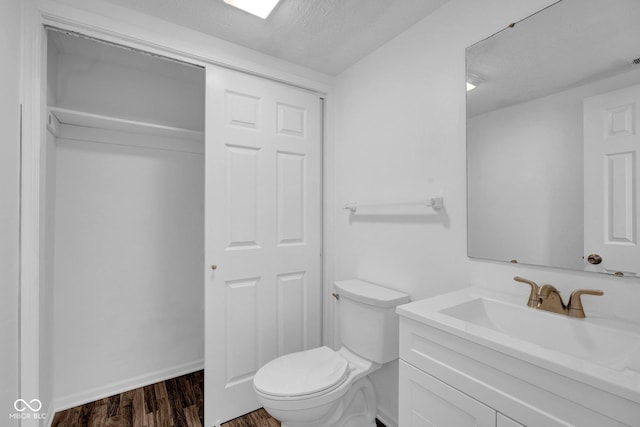 1847 Crystal Bay E Dr, Plainfield, IN 46168 - half bathroom with toilet, vanity, and wood finished floors