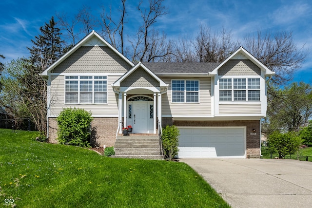 split foyer home featuring brick siding, an attached garage, driveway, and a front lawn
