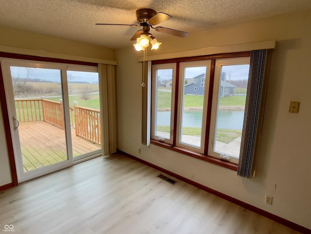 1 Vaught Rd, Hartford City, IN 47348 - unfurnished dining area with light wood-type flooring, visible vents, and baseboards