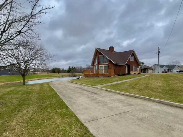1 Vaught Rd, Hartford City, IN 47348 - view of property exterior featuring a chimney, a water view, and a yard
