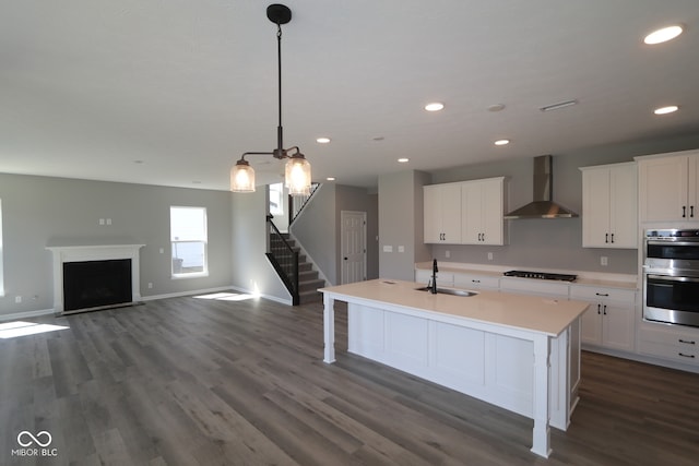 10609 Banyan Wood Ct, Indianapolis, IN 46239 - kitchen featuring wall chimney exhaust hood, a sink, black stovetop, double oven, and dark wood-style flooring