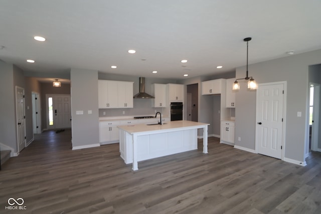 10609 Banyan Wood Ct, Indianapolis, IN 46239 - kitchen featuring wall chimney range hood, dark wood-type flooring, baseboards, white cabinetry, and recessed lighting