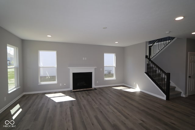 10609 Banyan Wood Ct, Indianapolis, IN 46239 - unfurnished living room with stairs, dark wood-style flooring, baseboards, recessed lighting, and a fireplace