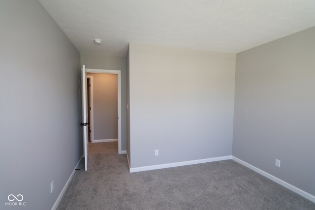 10609 Banyan Wood Ct, Indianapolis, IN 46239 - carpeted spare room featuring baseboards and a smoke detector