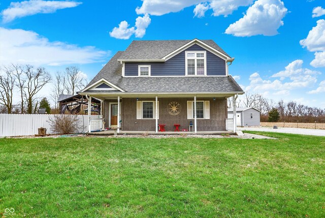 5371 Lue Ann Ln, Mooresville, IN 46158 - view of front of home with fence, a front yard, brick siding, covered porch, and a shingled roof