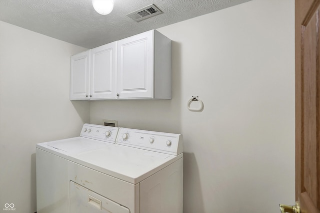 5371 Lue Ann Ln, Mooresville, IN 46158 - clothes washing area with visible vents, cabinet space, washer / dryer, and a textured ceiling