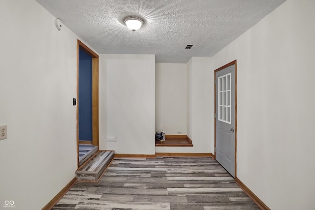 5371 Lue Ann Ln, Mooresville, IN 46158 - spare room with baseboards, visible vents, a textured ceiling, and wood finished floors