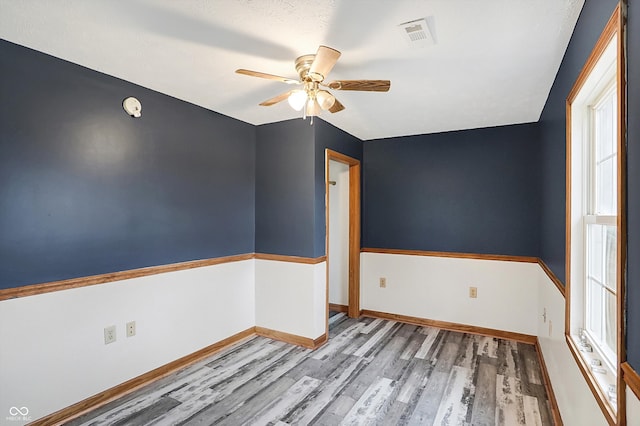 5371 Lue Ann Ln, Mooresville, IN 46158 - spare room with visible vents, baseboards, ceiling fan, and wood finished floors
