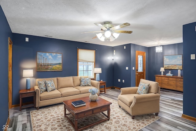 5371 Lue Ann Ln, Mooresville, IN 46158 - living room featuring visible vents, a textured ceiling, wood finished floors, and a ceiling fan