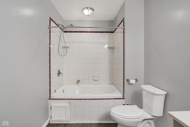 5371 Lue Ann Ln, Mooresville, IN 46158 - full bath featuring toilet, wood finished floors, a textured ceiling, baseboards, and shower / bath combination