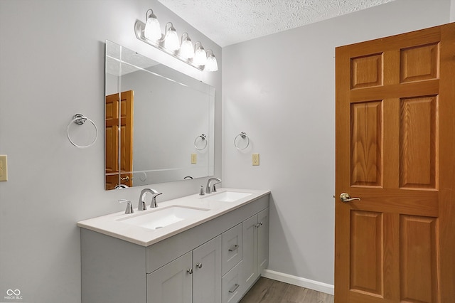 5371 Lue Ann Ln, Mooresville, IN 46158 - full bath with baseboards, double vanity, a textured ceiling, and a sink