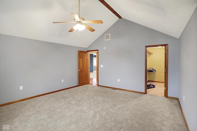 5371 Lue Ann Ln, Mooresville, IN 46158 - unfurnished bedroom with high vaulted ceiling, visible vents, baseboards, light carpet, and a walk in closet