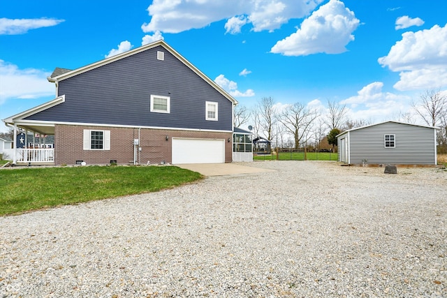 5371 Lue Ann Ln, Mooresville, IN 46158 - view of property exterior with a lawn, gravel driveway, a garage, and brick siding