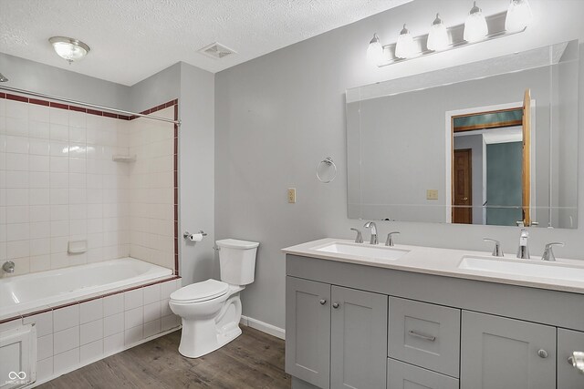 5371 Lue Ann Ln, Mooresville, IN 46158 - bathroom featuring toilet, a sink, a textured ceiling, and wood finished floors