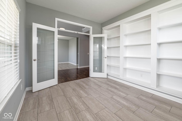 2314 Angelina Way, Greenwood, IN 46143 - empty room with wood tiled floor, baseboards, and french doors