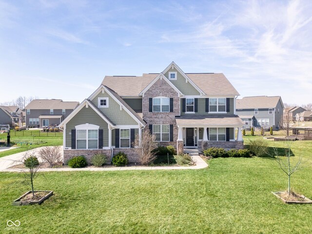 2314 Angelina Way, Greenwood, IN 46143 - craftsman-style house featuring fence, a front lawn, and a residential view