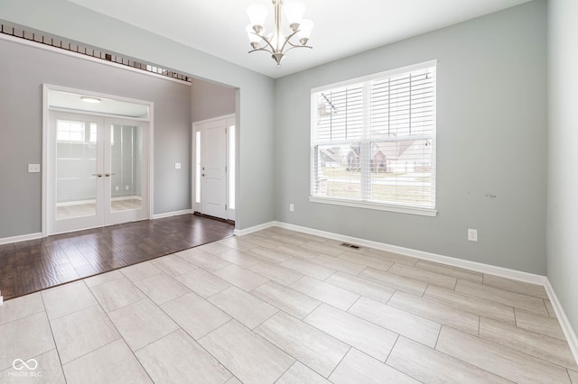 2314 Angelina Way, Greenwood, IN 46143 - foyer entrance featuring visible vents, light wood finished floors, baseboards, french doors, and a notable chandelier