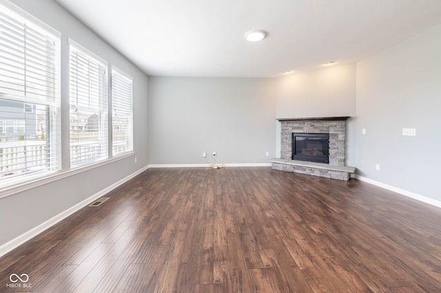 2314 Angelina Way, Greenwood, IN 46143 - unfurnished living room featuring baseboards, a fireplace, visible vents, and dark wood finished floors
