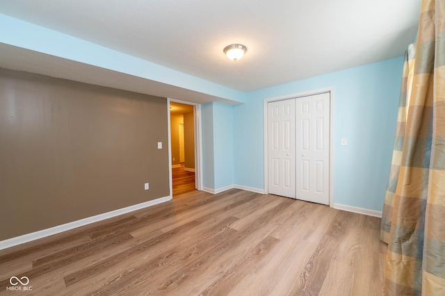 2314 Angelina Way, Greenwood, IN 46143 - unfurnished bedroom featuring baseboards, wood finished floors, and a closet