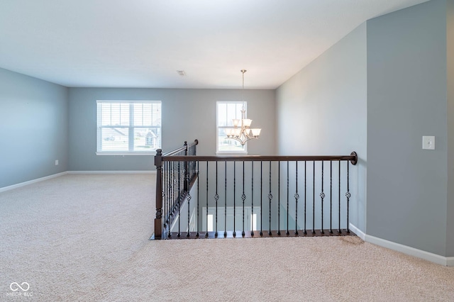 2314 Angelina Way, Greenwood, IN 46143 - hallway with an upstairs landing, carpet, baseboards, and a chandelier