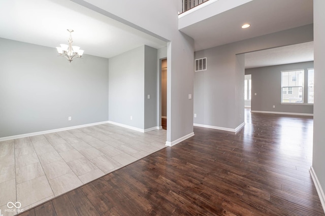 2314 Angelina Way, Greenwood, IN 46143 - spare room featuring a chandelier, dark wood-type flooring, baseboards, visible vents, and recessed lighting