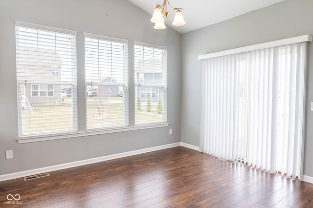 2314 Angelina Way, Greenwood, IN 46143 - unfurnished room with dark wood-style flooring, visible vents, a chandelier, baseboards, and vaulted ceiling