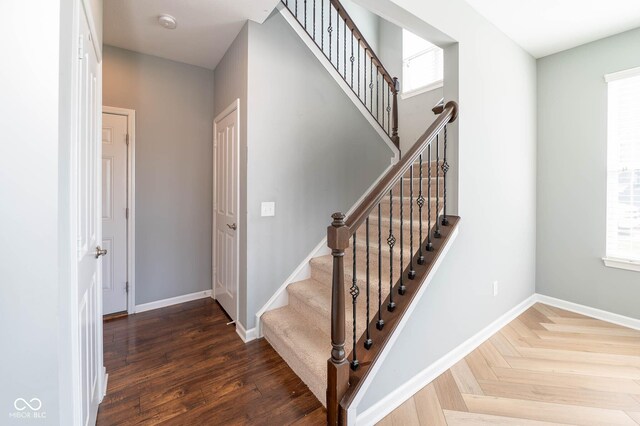 2314 Angelina Way, Greenwood, IN 46143 - stairway featuring baseboards, parquet flooring, and plenty of natural light