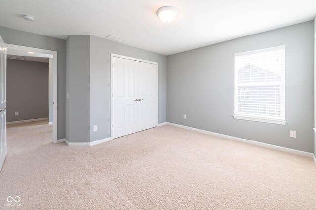 2314 Angelina Way, Greenwood, IN 46143 - unfurnished bedroom with a closet, visible vents, baseboards, and carpet