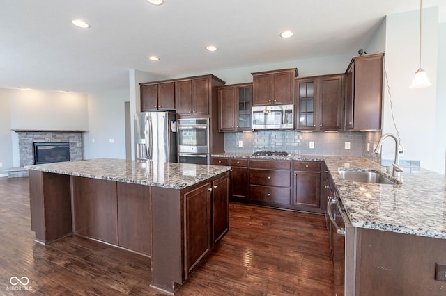 2314 Angelina Way, Greenwood, IN 46143 - kitchen with dark wood-style floors, a sink, backsplash, and appliances with stainless steel finishes