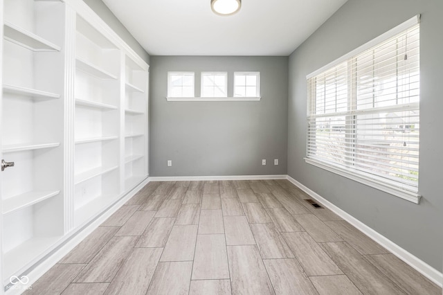 2314 Angelina Way, Greenwood, IN 46143 - spare room with baseboards, visible vents, and wood finish floors