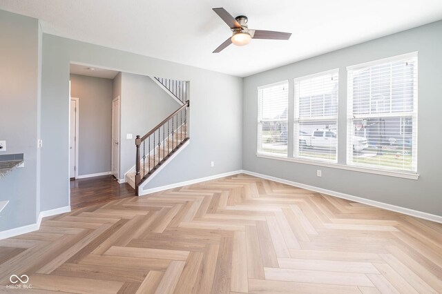 2314 Angelina Way, Greenwood, IN 46143 - unfurnished room with baseboards, stairway, and a ceiling fan