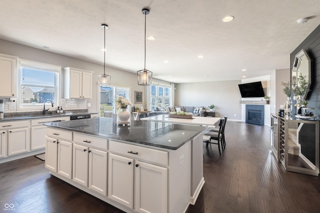 12959 Balfour Rd, Fishers, IN 46037 - kitchen with a sink, a center island, a fireplace, open floor plan, and recessed lighting