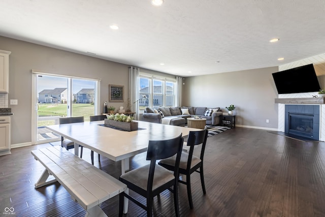 12959 Balfour Rd, Fishers, IN 46037 - dining space with recessed lighting, baseboards, dark wood-style floors, and a tile fireplace