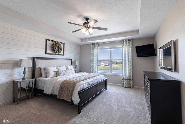 12959 Balfour Rd, Fishers, IN 46037 - bedroom featuring a textured ceiling, light carpet, ceiling fan, baseboards, and wood walls
