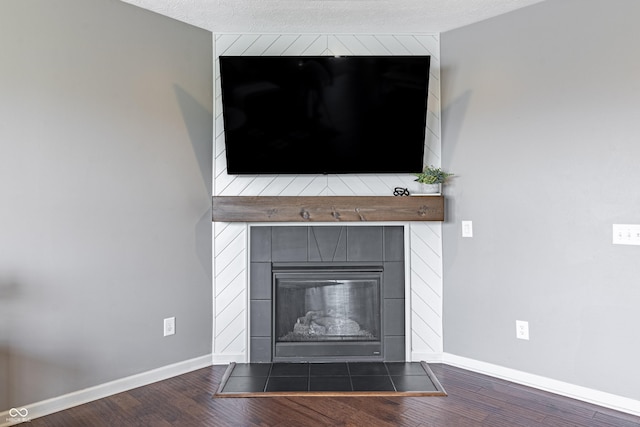 12959 Balfour Rd, Fishers, IN 46037 - detailed view of wood finished floors, baseboards, and a tiled fireplace