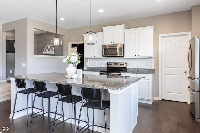12959 Balfour Rd, Fishers, IN 46037 - kitchen featuring appliances with stainless steel finishes, dark wood-type flooring, a center island, decorative backsplash, and recessed lighting