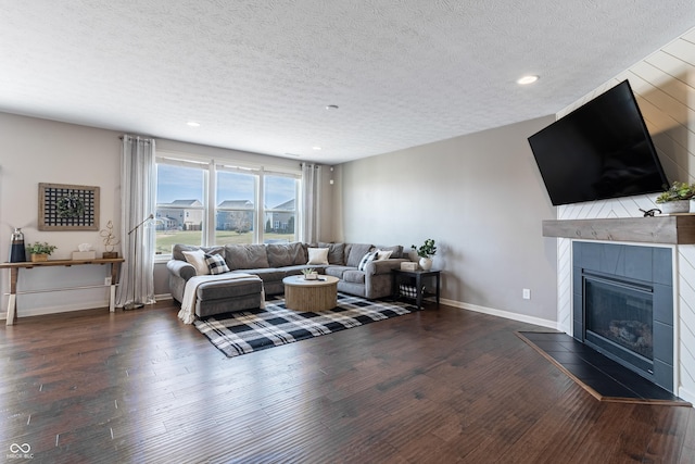 12959 Balfour Rd, Fishers, IN 46037 - living room featuring a textured ceiling, dark wood-style floors, a fireplace, baseboards, and recessed lighting