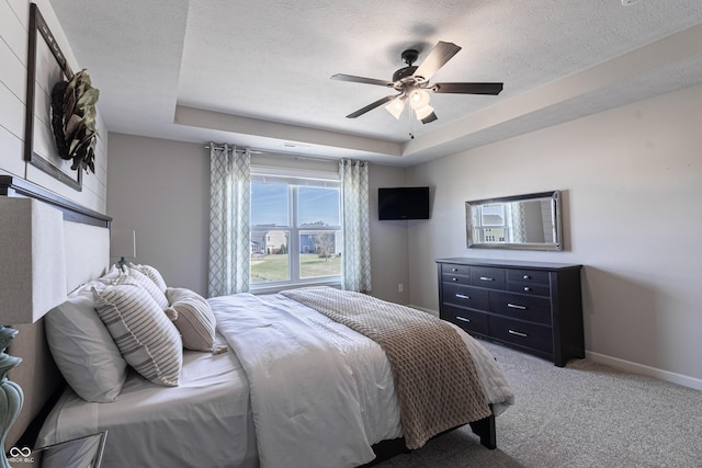 12959 Balfour Rd, Fishers, IN 46037 - bedroom with a raised ceiling, light colored carpet, baseboards, a textured ceiling, and a ceiling fan