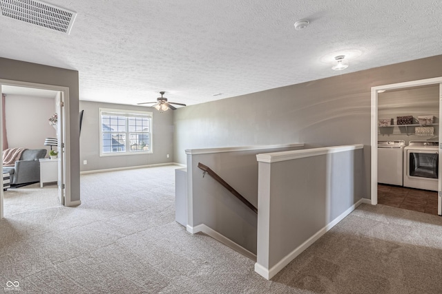 12959 Balfour Rd, Fishers, IN 46037 - hallway with washing machine and clothes dryer, an upstairs landing, carpet, a textured ceiling, and baseboards