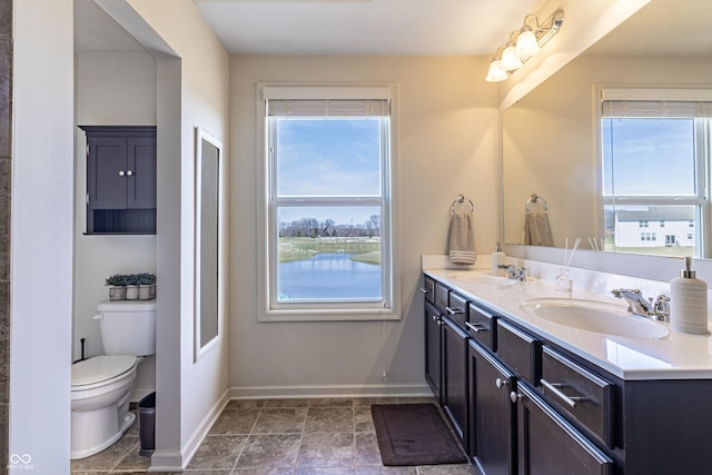 12959 Balfour Rd, Fishers, IN 46037 - bathroom with double vanity, baseboards, and toilet