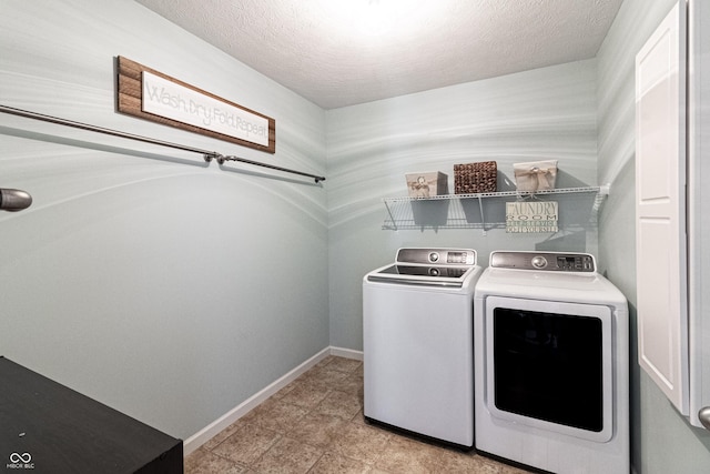 12959 Balfour Rd, Fishers, IN 46037 - laundry room with washer and clothes dryer, baseboards, and a textured ceiling