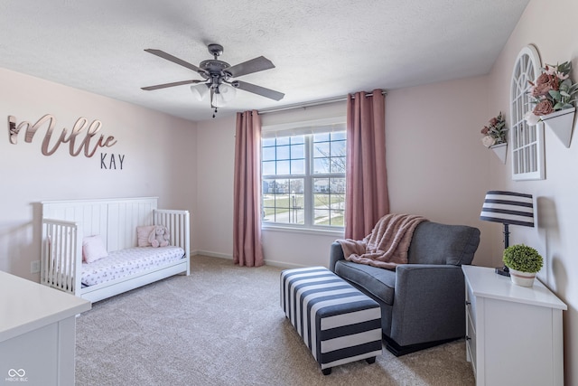 12959 Balfour Rd, Fishers, IN 46037 - bedroom featuring light colored carpet, a textured ceiling, baseboards, a crib, and a ceiling fan