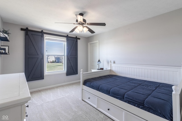 12959 Balfour Rd, Fishers, IN 46037 - bedroom featuring a barn door, light carpet, baseboards, and ceiling fan