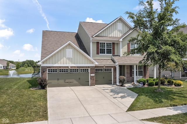 12959 Balfour Rd, Fishers, IN 46037 - view of front of house with board and batten siding, concrete driveway, a water view, and brick siding