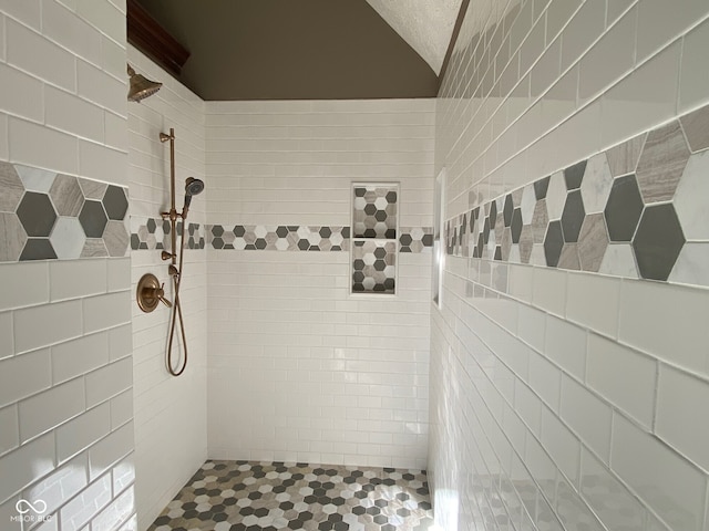 11967 Windpointe Pass, Carmel, IN 46033 - full bathroom with tiled shower, lofted ceiling, tile patterned floors, and tile walls