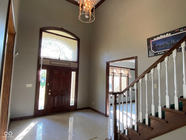 11967 Windpointe Pass, Carmel, IN 46033 - entryway featuring a towering ceiling, baseboards, light tile patterned floors, stairway, and a chandelier